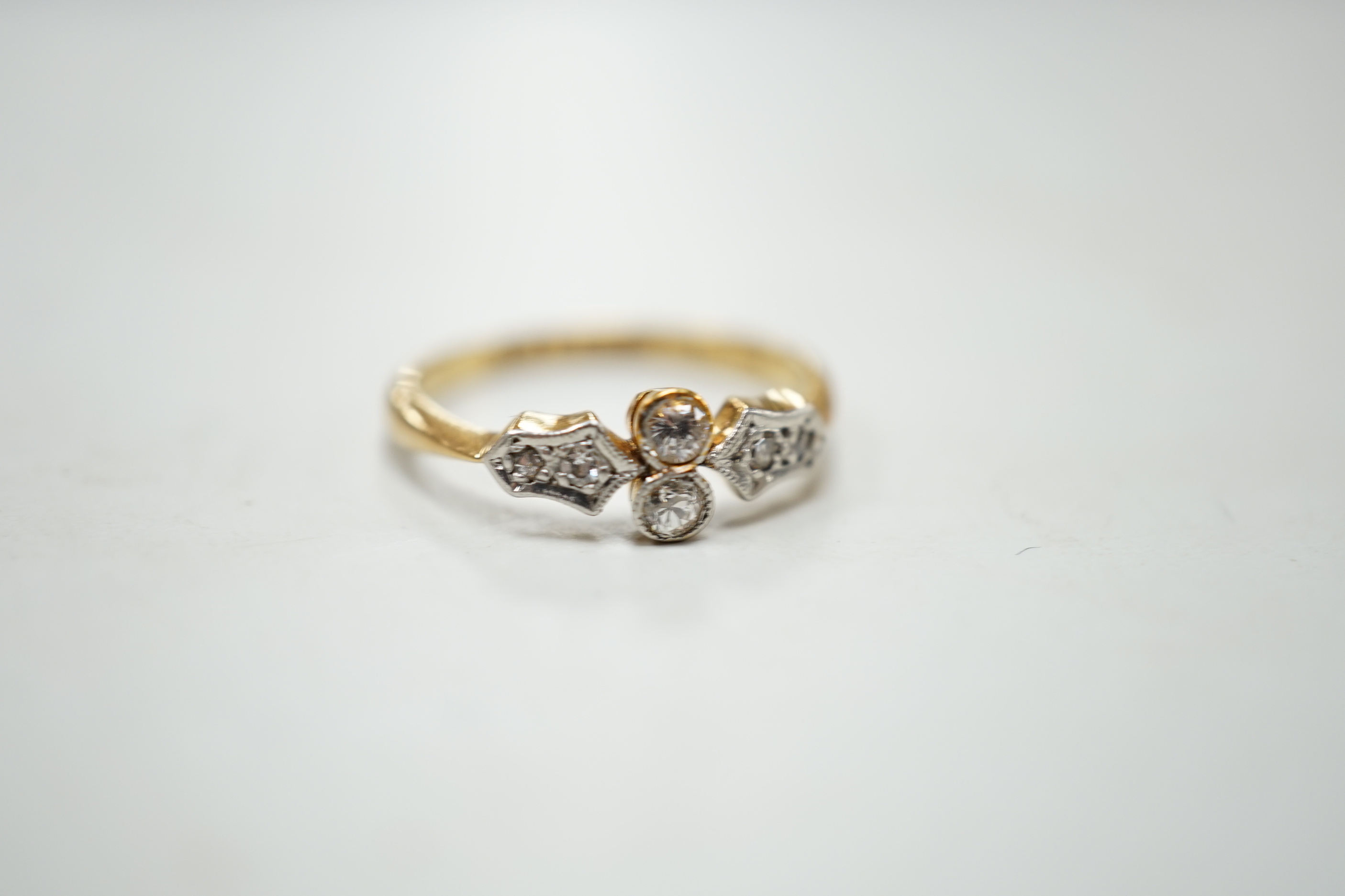 A 1920's 18ct, plat and six stone diamond chip set cluster ring, size M, gross weight 2.5 grams.